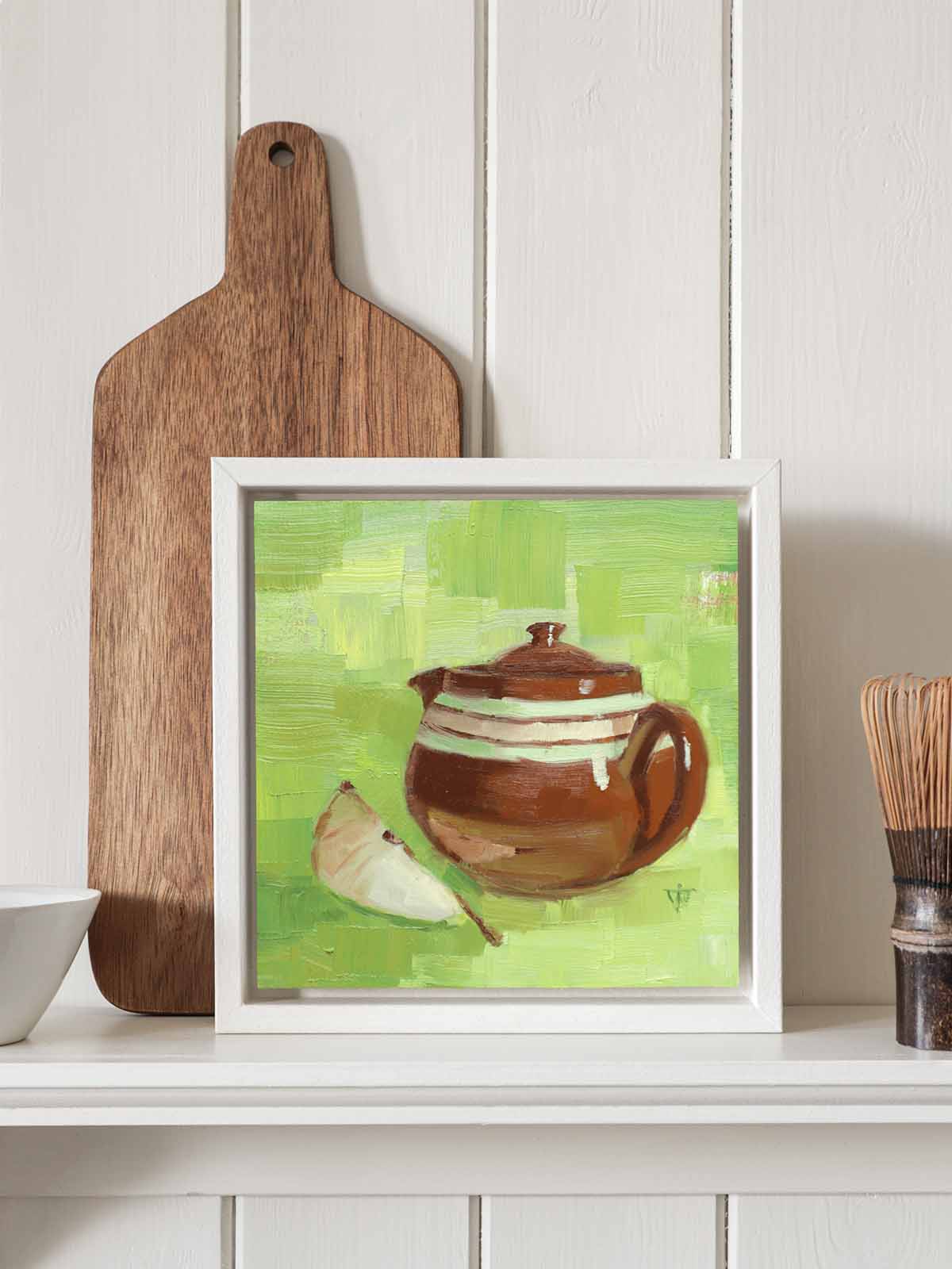 Small teapot painting with white frame displayed on kitchen shelf