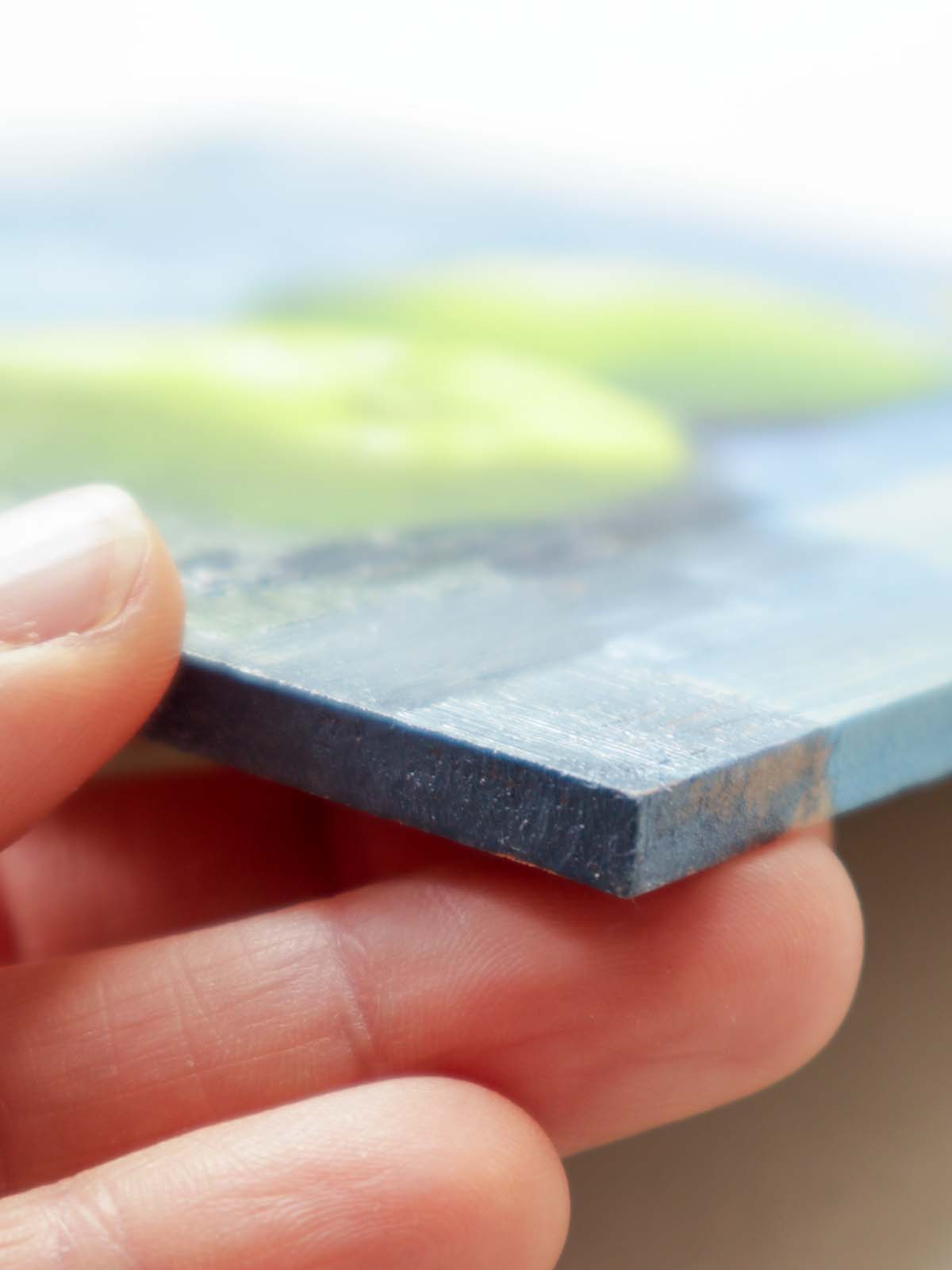 Side edge of apple painting showing thickness of painting board