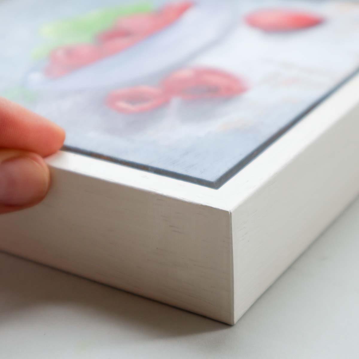 Side view of small oil painting showing artwork and tray frame depth.