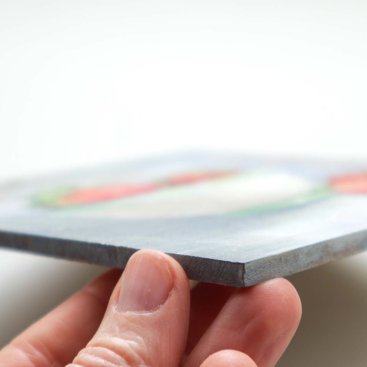 Side edge of strawberry painting showing thickness of painting board