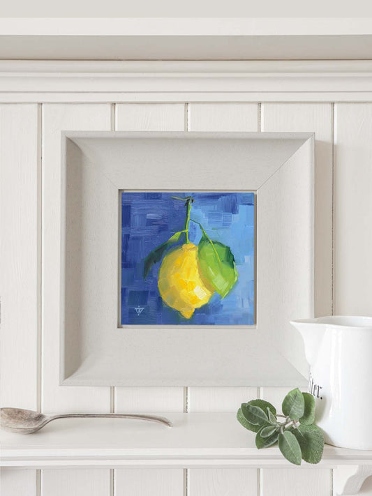 Lemon painting in grey frame hanging on kitchen wall