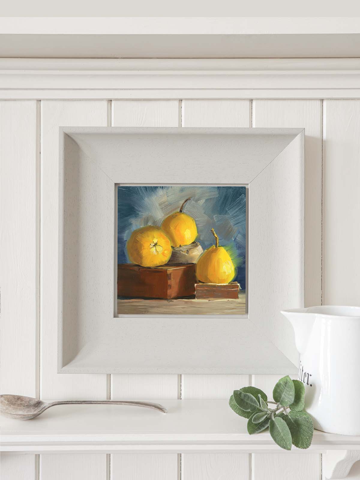 Yellow pears painting in modern grey frame displayed in contemporary kitchen