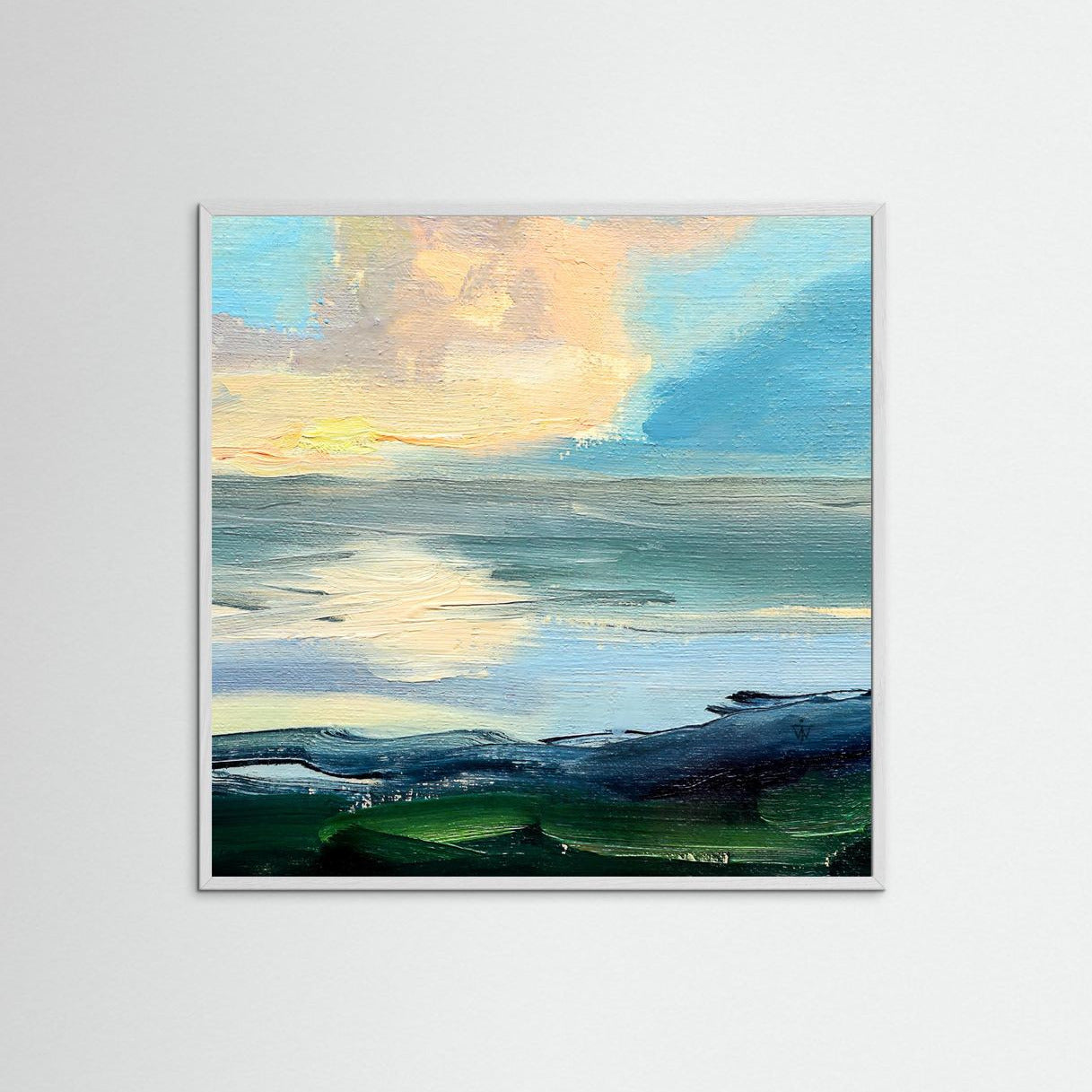 Framed artwork of a clouds above sea on a white wall.