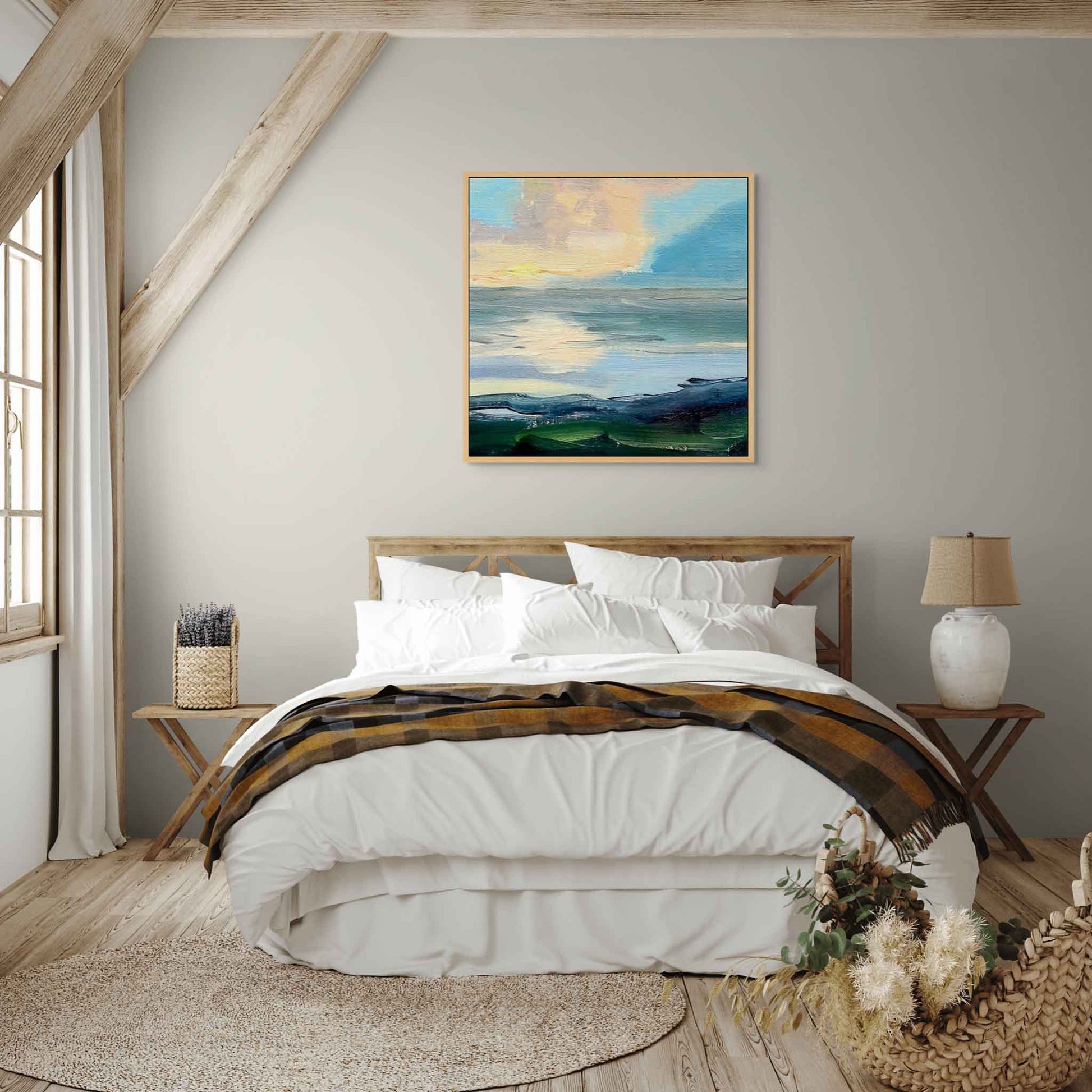 Peaceful wall painting of clouds above the sea in bedroom with a wooden bed and nightstands and white walls.