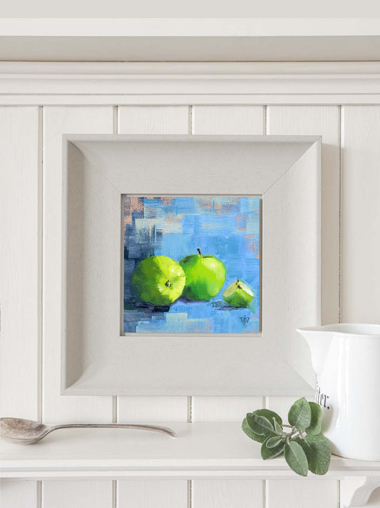 Apple painting in modern grey frame hanging on contemporary kitchen wall