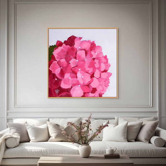 Oversized floral wall art of pink hydrangea above a white sofa in a living room.