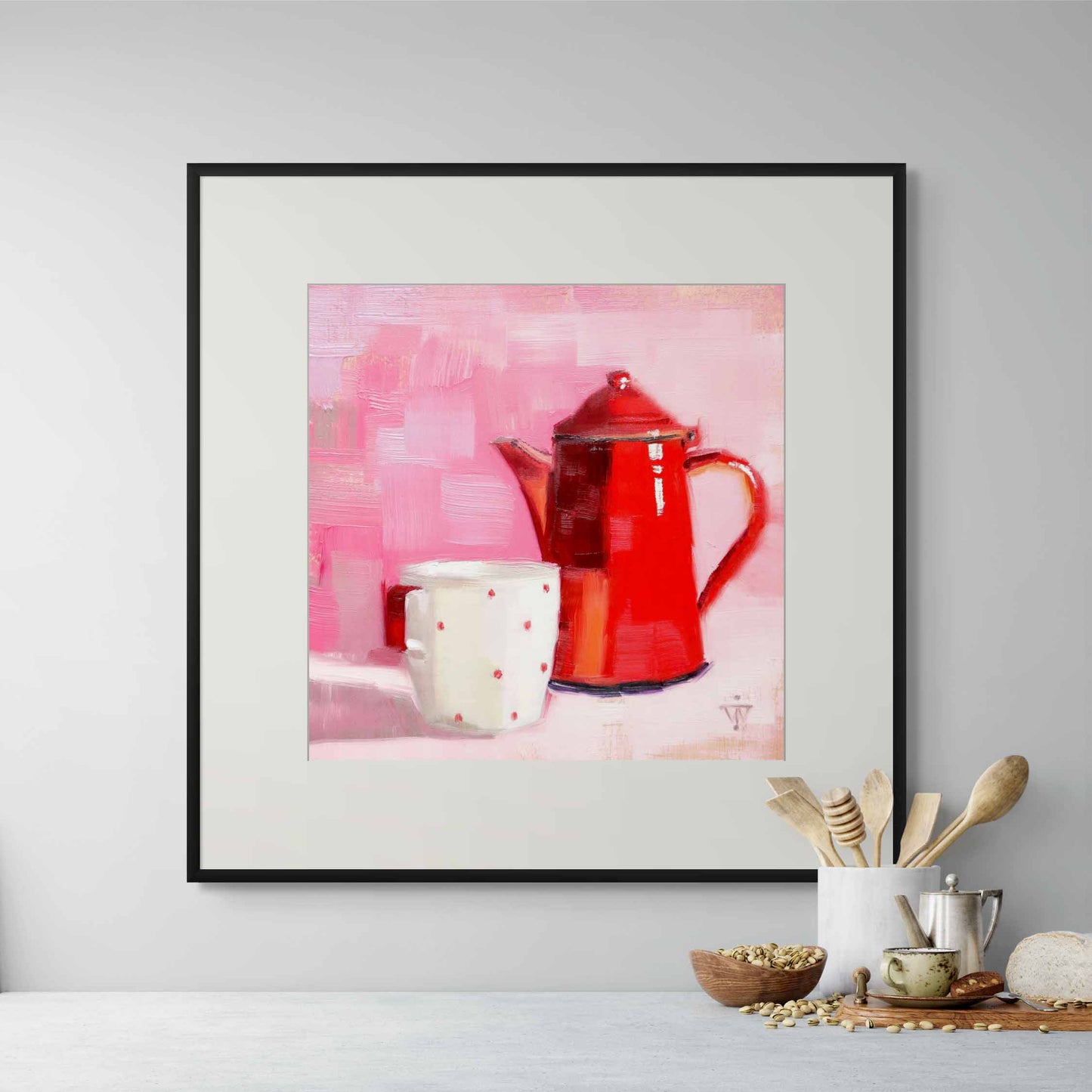 Framed artwork of a red vintage coffeepot and white cup on a pink background, displayed on a wall.