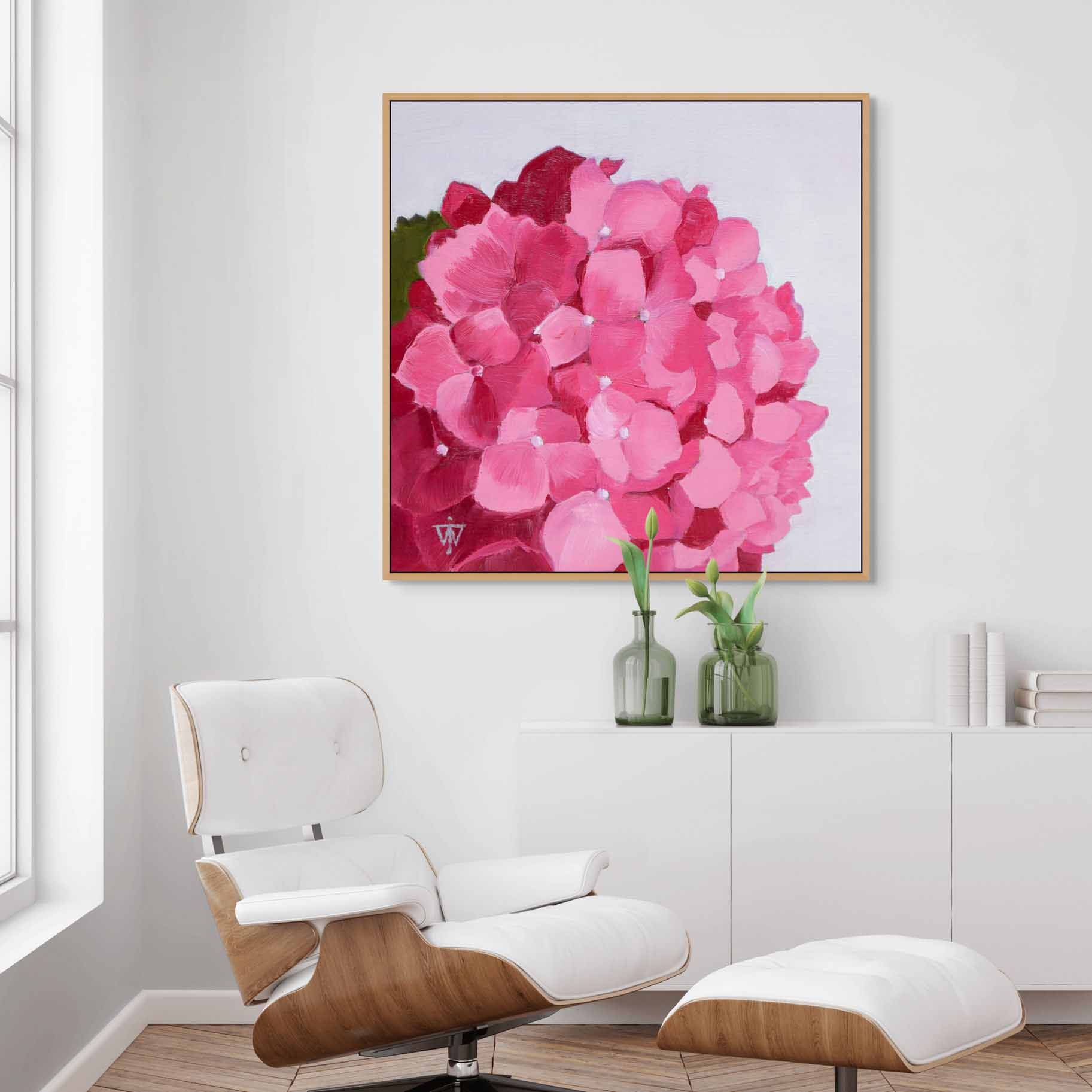Pink hydrangea gallery wrapped canvas art by Jacqueline Wagner in modern interior with a white arm chair and sideboard.