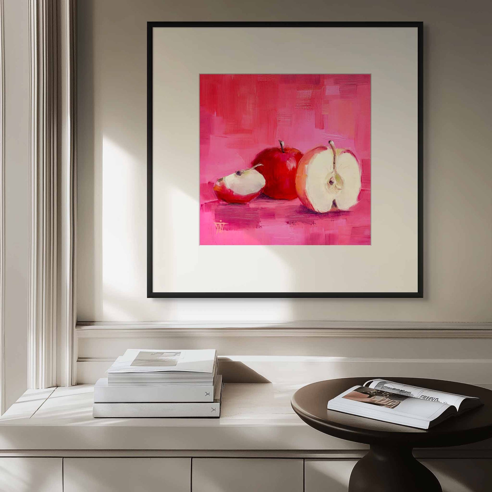 Framed artwork with apples on a wall above a contemporary sideboard