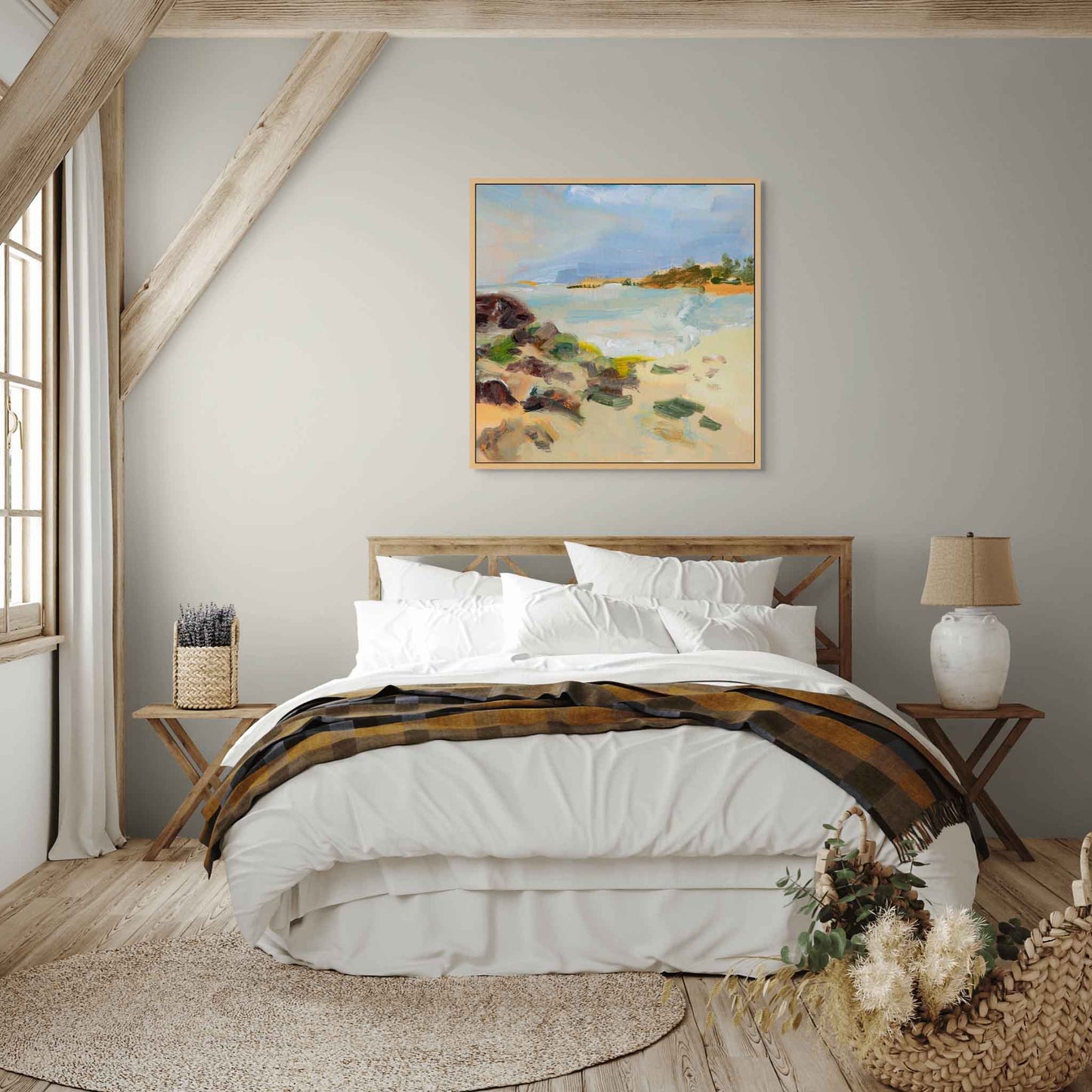 Artwork above bed – a painting of a beach scene in a wooden tray frame in a calm bedroom with white and wood accent.