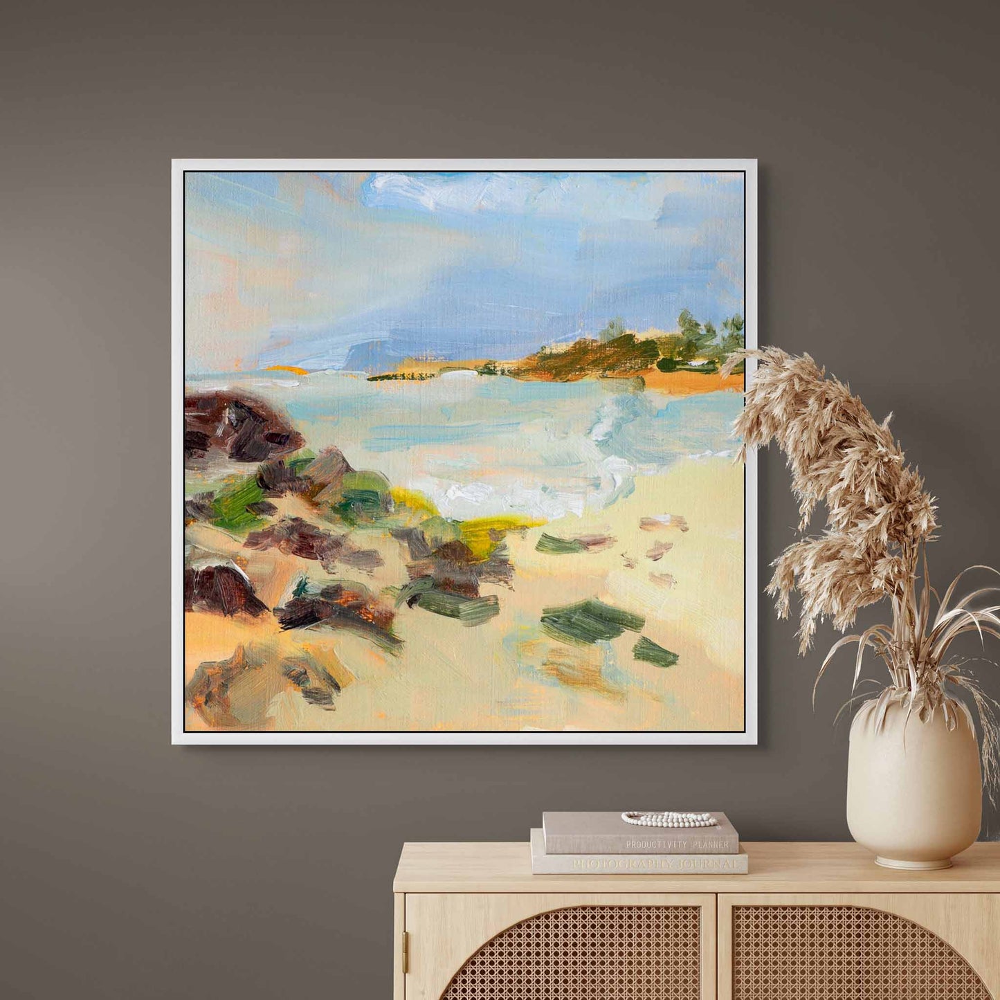 Framed  oil painting canvas print  on a grey wall above a cabinet with decorative items.