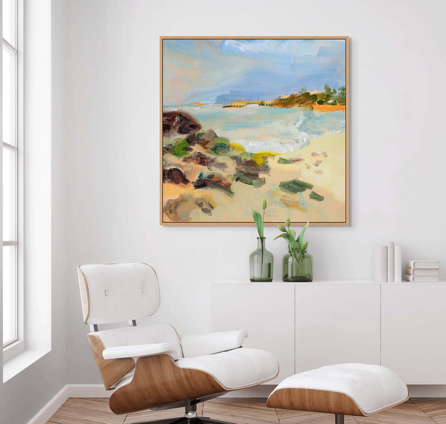 Abstract realism canvas print of beach painting on the wall in a modern living room with a white armchair.
