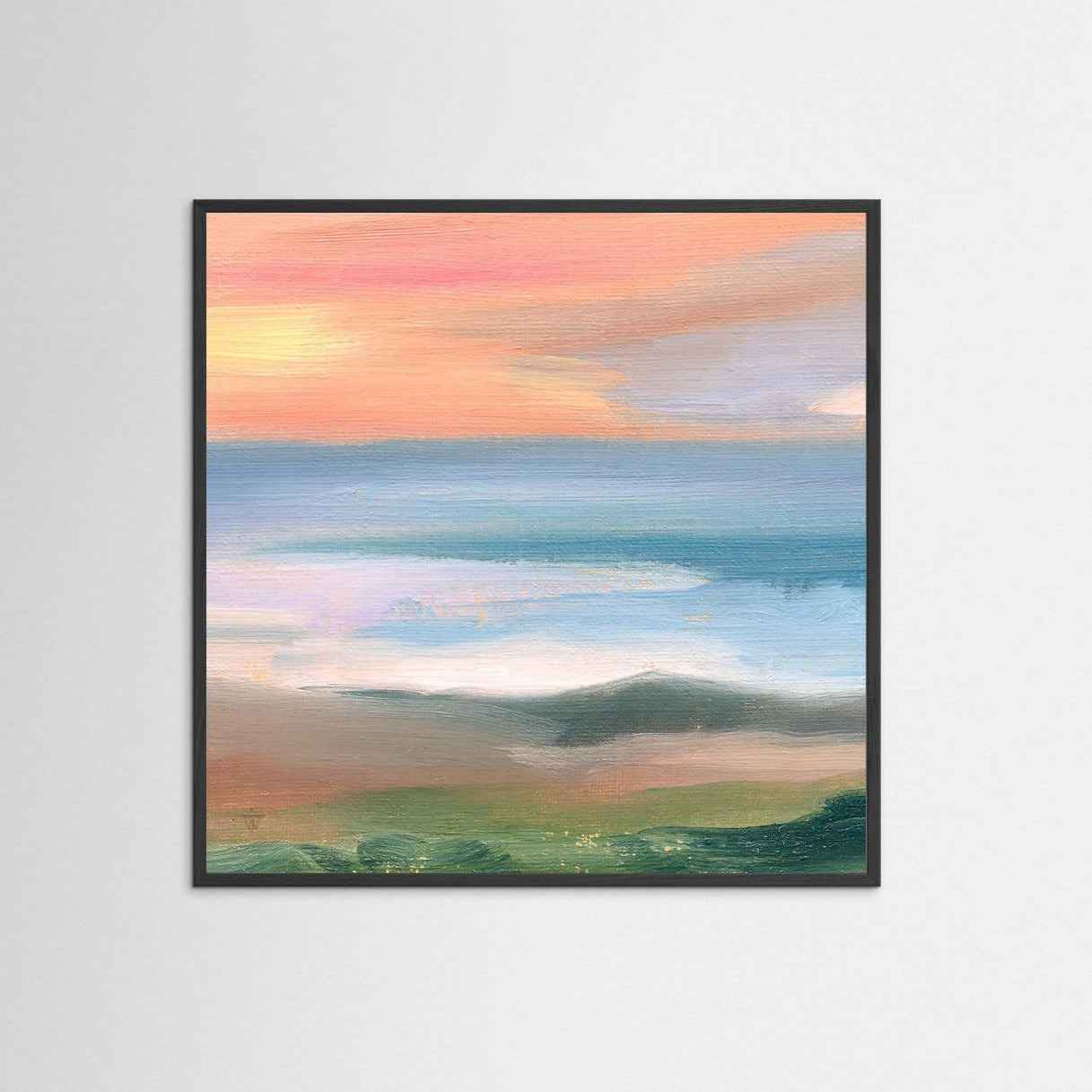 Framed artwork of a landscape with a sunrise over water on a white wall
