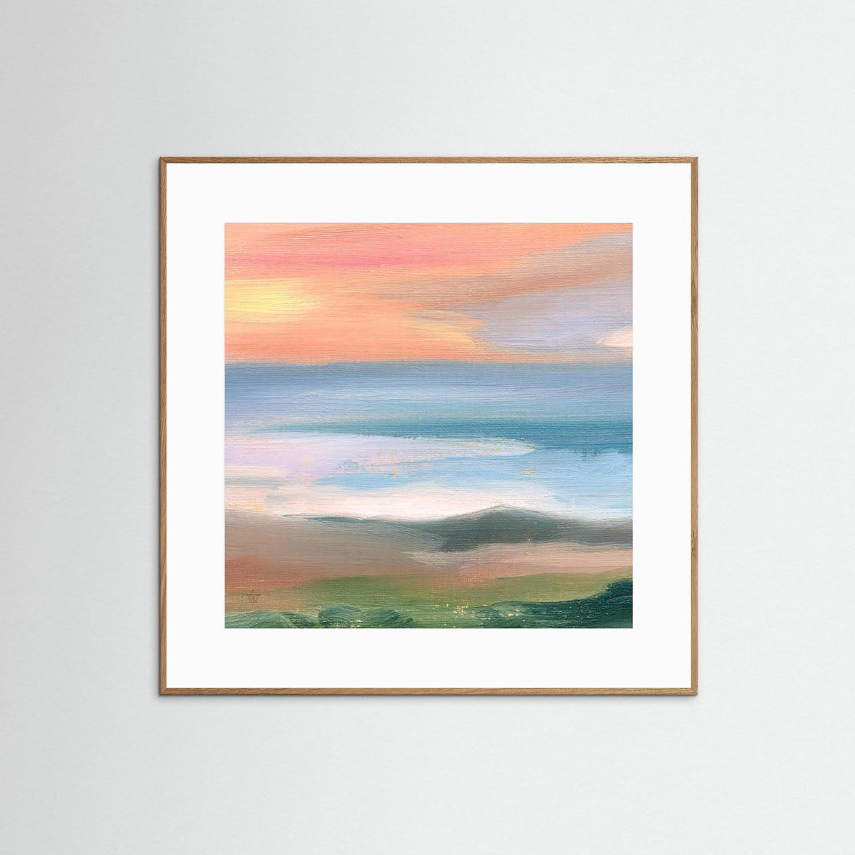 Framed artwork of a landscape with a colorful sky on a white wall