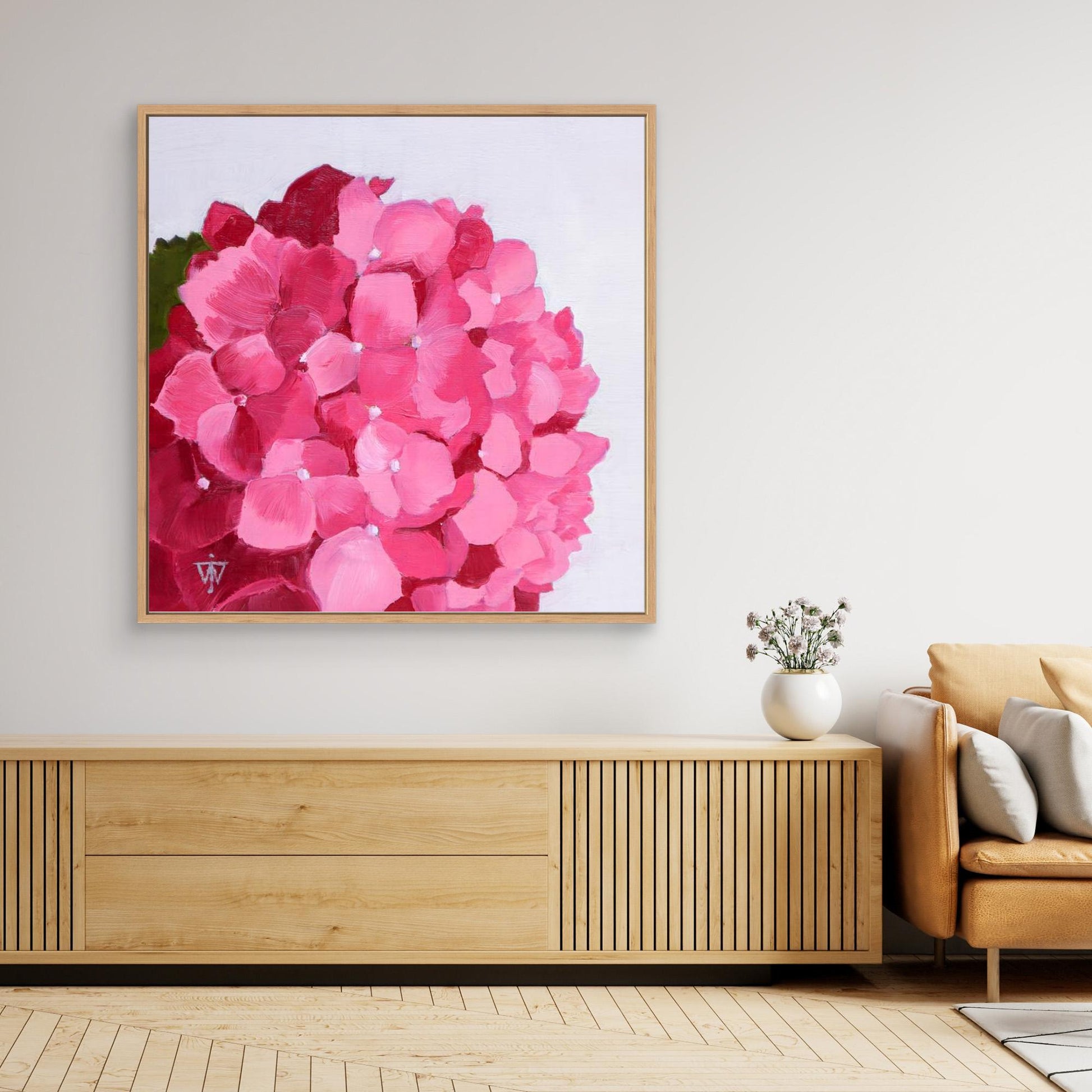 Huge floral canvas print in natural wood floating frame above wooden sideboard