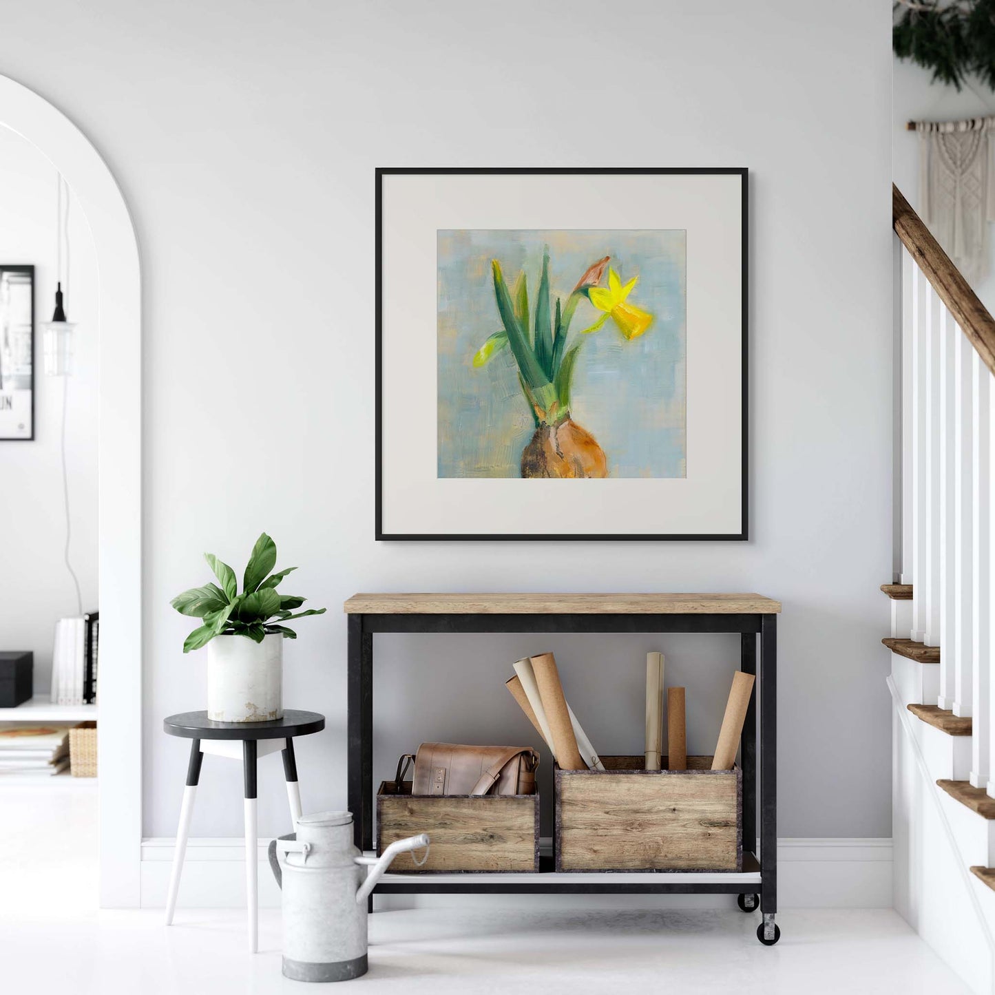 Framed floral artwork above a console table in a home interior.