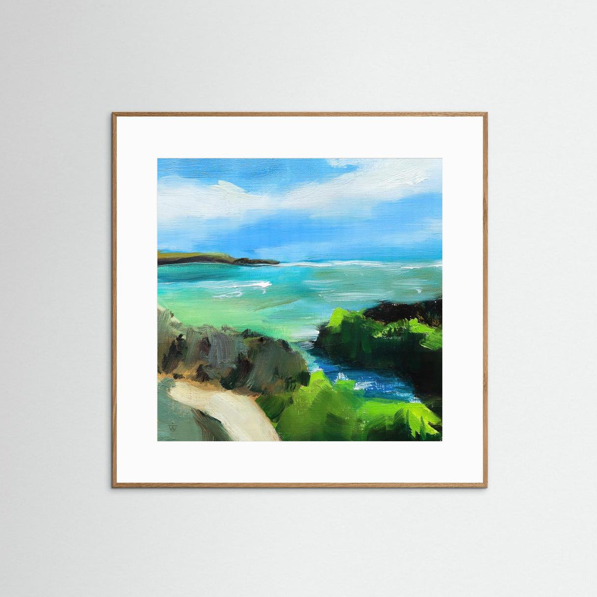 Framed painting of a coastal landscape with blue sky, turquoise sea and green cliffs.
